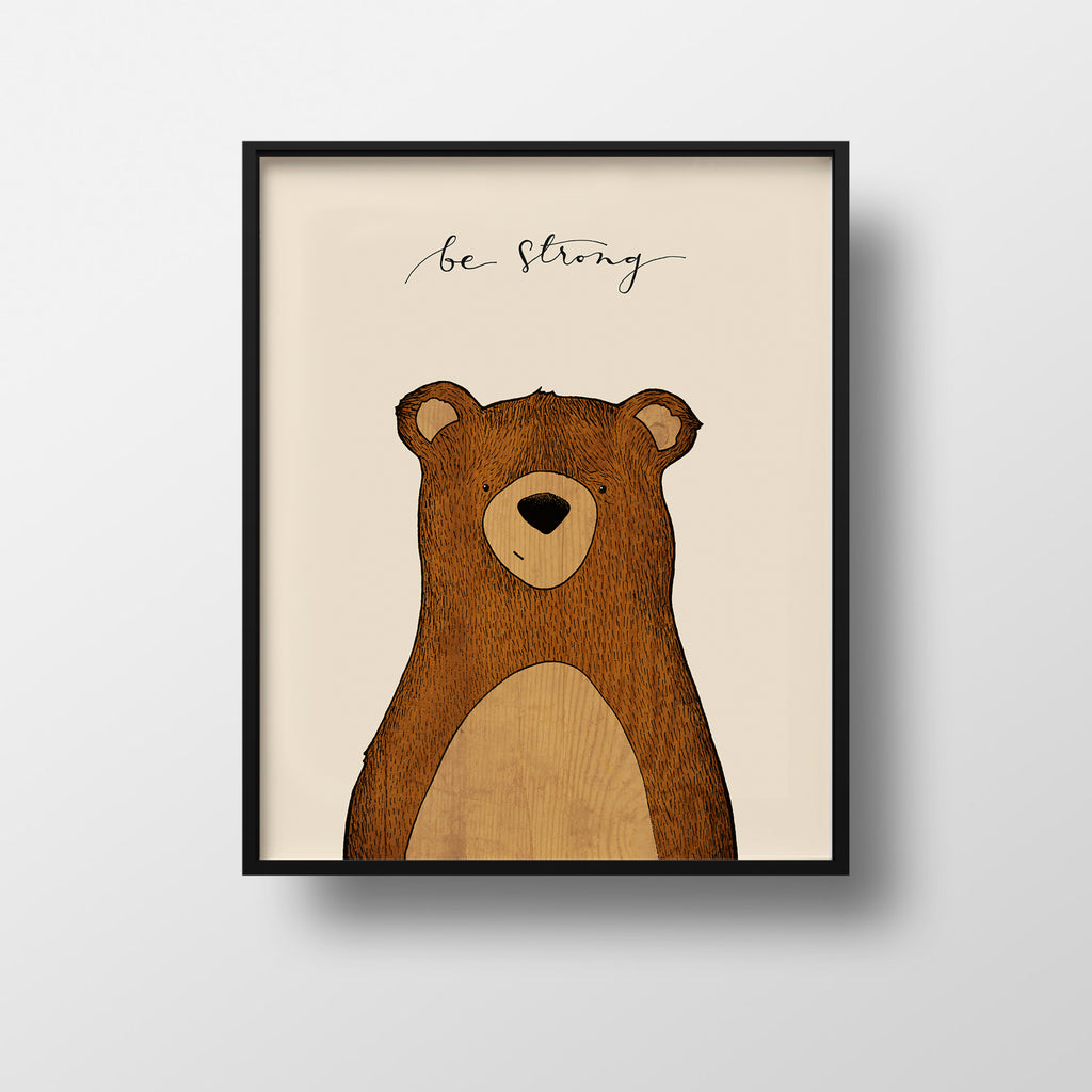 Illustration of a smiling woodland bear on a tan background with the words "be strong" written in cursive at the top 