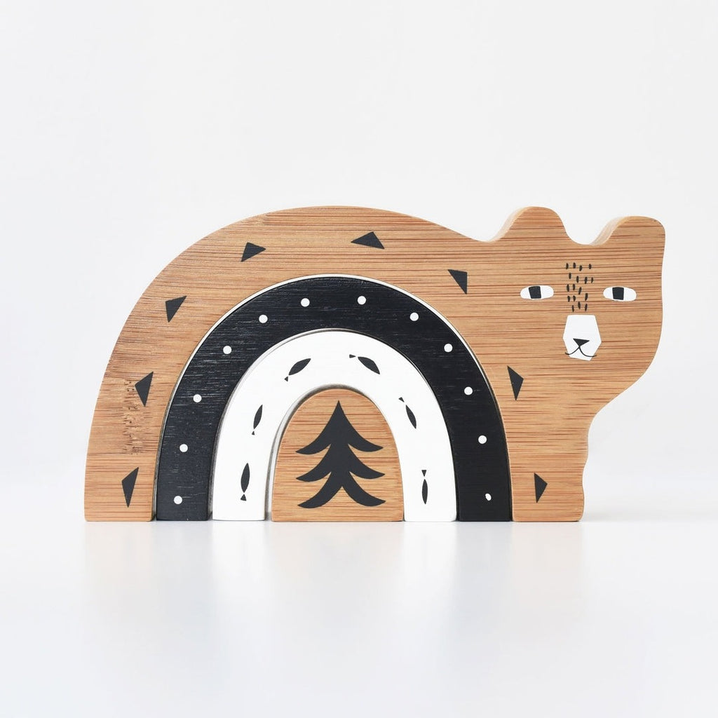 Bamboo nesting toy in the shape of a bear with minimal designs in brown, black, and white.
